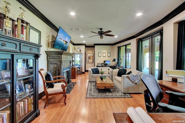 living area with light wood finished floors, ornamental molding, french doors, and a ceiling fan