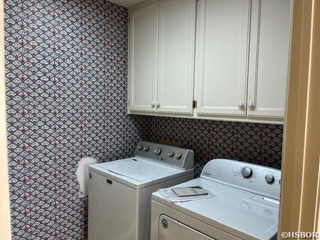 laundry room with cabinet space and separate washer and dryer