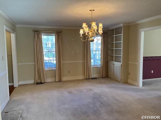 unfurnished dining area with baseboards, an inviting chandelier, ornamental molding, a textured ceiling, and carpet flooring