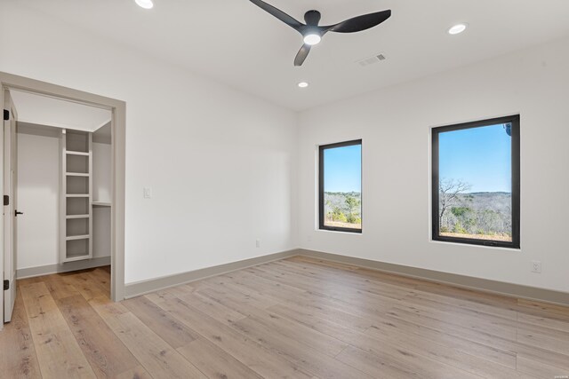 interior space with light wood-style floors, baseboards, a ceiling fan, and recessed lighting