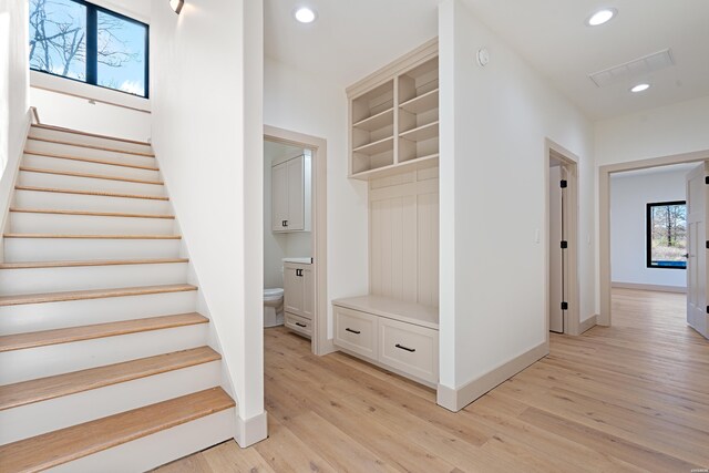 interior space with light wood finished floors, visible vents, baseboards, and recessed lighting