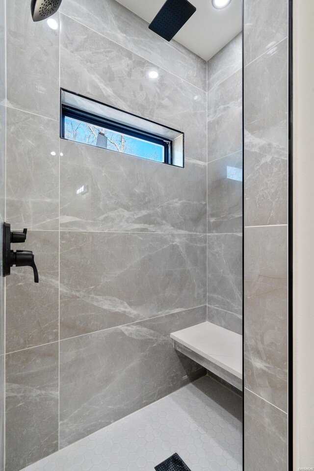 bathroom with a tile shower