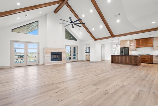 unfurnished living room featuring light wood-style flooring, visible vents, ceiling fan, and french doors