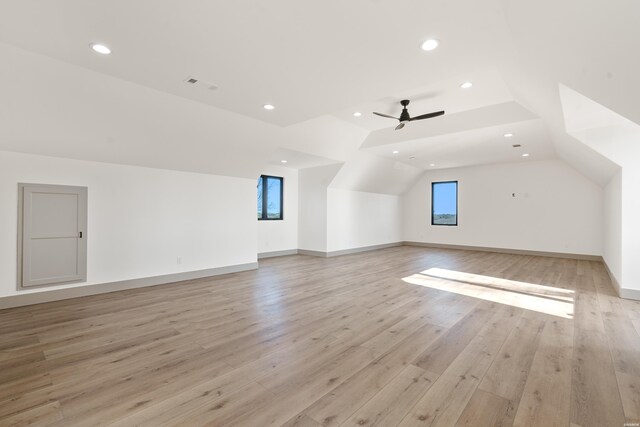 additional living space with light wood-style floors, recessed lighting, vaulted ceiling, and ceiling fan