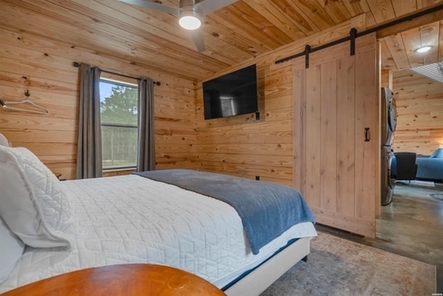 1136 Arlie Moore Rd, Bismarck, AR 71929 - bedroom featuring a barn door, wooden walls, wood ceiling, and finished concrete floors