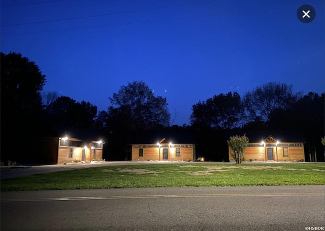 ranch-style home featuring a yard, a garage, and driveway