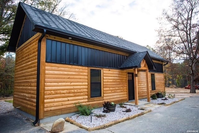 view of home's exterior featuring roof with shingles