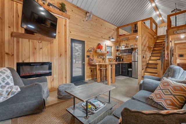 1136 Arlie Moore Rd, Bismarck, AR 71929 - living area with a glass covered fireplace, high vaulted ceiling, wood walls, and stairs