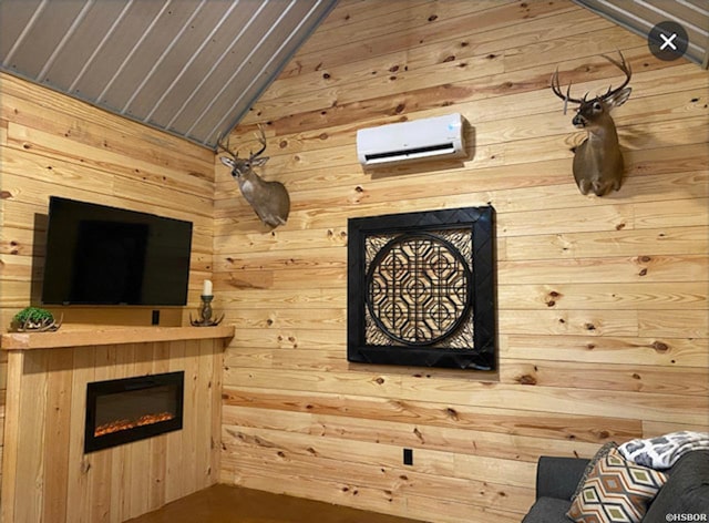 unfurnished living room with lofted ceiling, wooden walls, an AC wall unit, and a glass covered fireplace