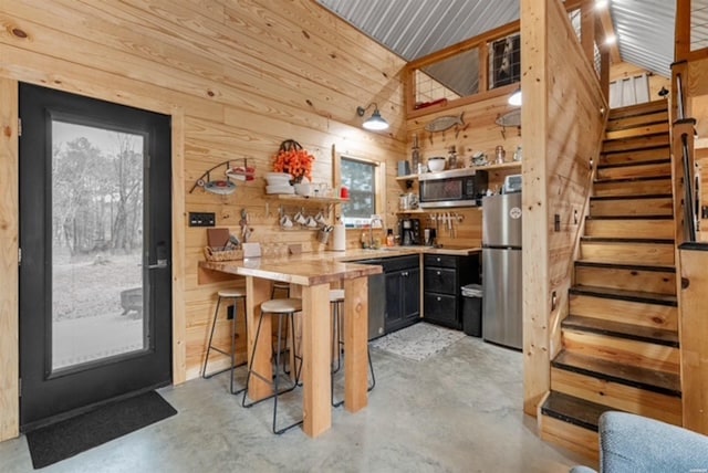 1136 Arlie Moore Rd, Bismarck, AR 71929 - kitchen with wooden walls, appliances with stainless steel finishes, concrete flooring, and open shelves