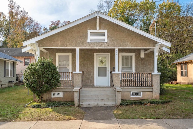 bungalow-style home featuring a porch and stucco siding