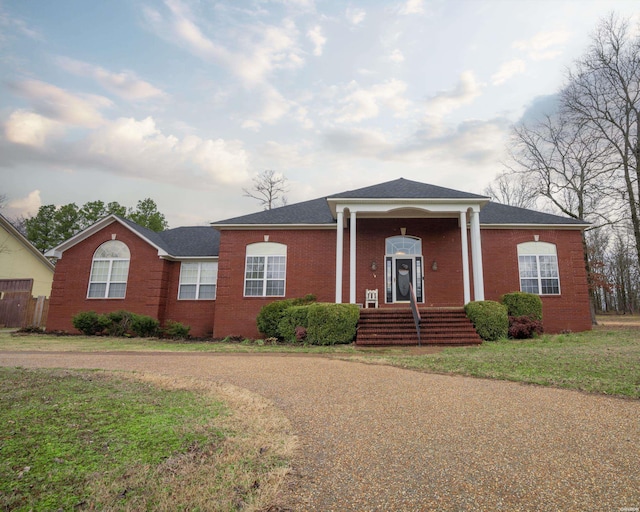 view of front of house featuring a front yard and brick siding