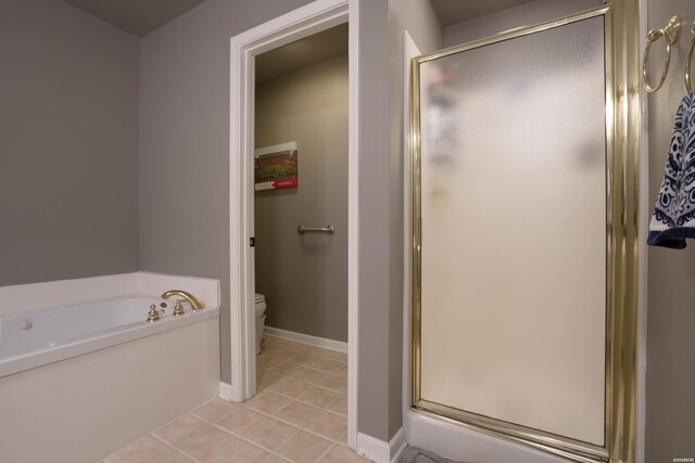 bathroom featuring a garden tub, a stall shower, tile patterned flooring, and toilet