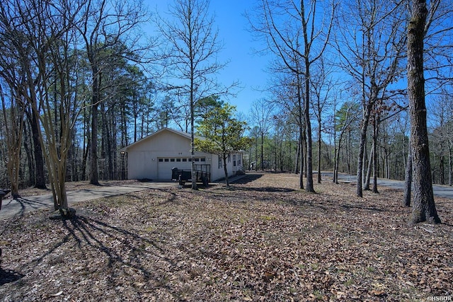 view of yard featuring driveway and an attached garage