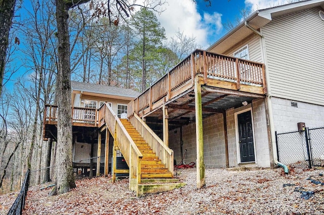 back of house featuring stairs, fence, and a wooden deck