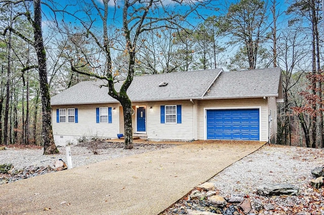 ranch-style house with an attached garage, crawl space, driveway, and roof with shingles