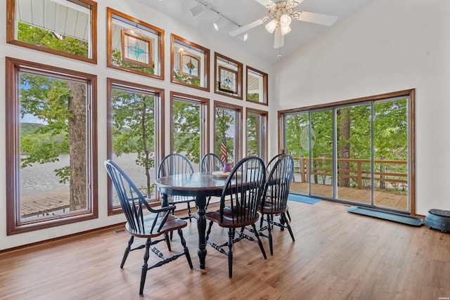 18 Escondite Ln, Hot Springs Village, AR 71909 - dining room featuring wood finished floors, plenty of natural light, a towering ceiling, a ceiling fan, and baseboards