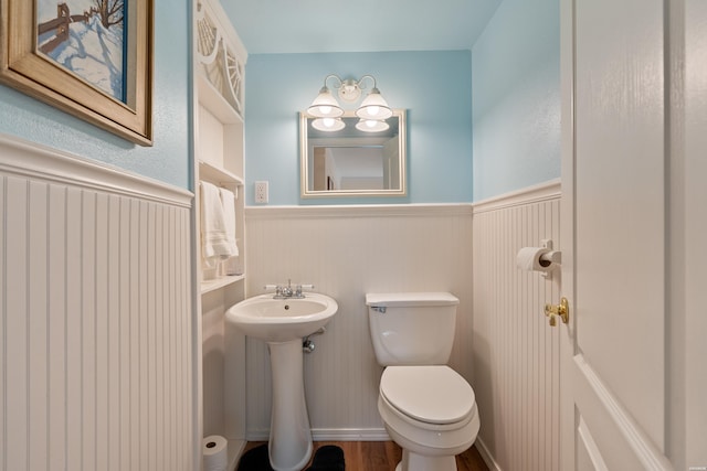 18 Escondite Ln, Hot Springs Village, AR 71909 - bathroom featuring a wainscoted wall, toilet, a sink, and wood finished floors