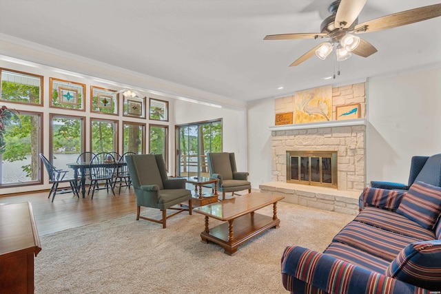 18 Escondite Ln, Hot Springs Village, AR 71909 - living area featuring ceiling fan, a stone fireplace, ornamental molding, and wood finished floors