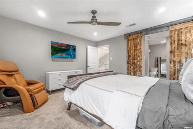 bedroom with light carpet, a barn door, visible vents, a ceiling fan, and recessed lighting