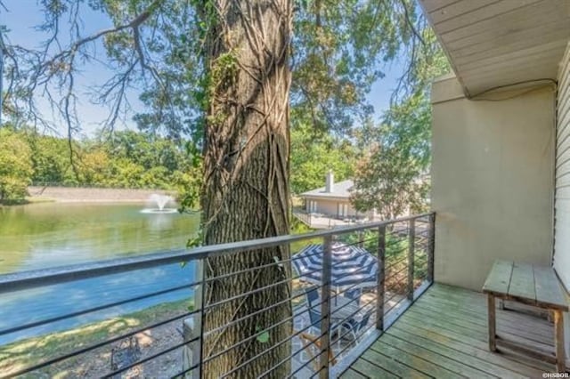 balcony featuring a water view and a grill