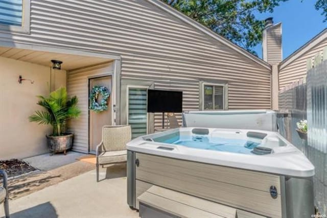 view of patio / terrace with a hot tub