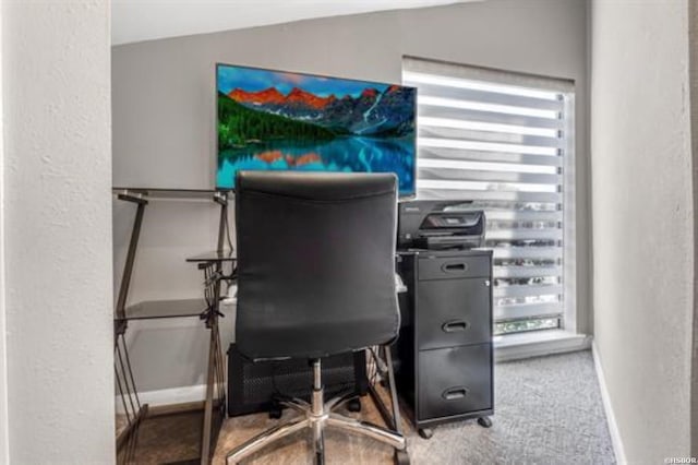 home office with lofted ceiling, carpet, and baseboards