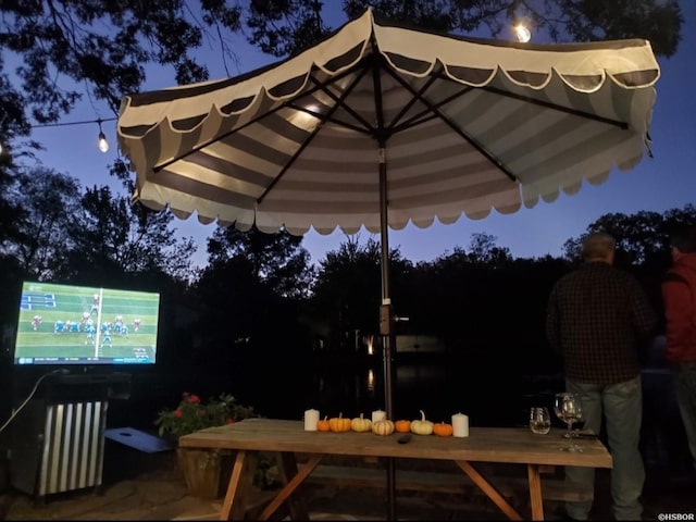 patio at night with outdoor dining area