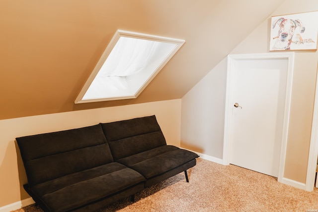 living area featuring lofted ceiling, baseboards, and carpet flooring