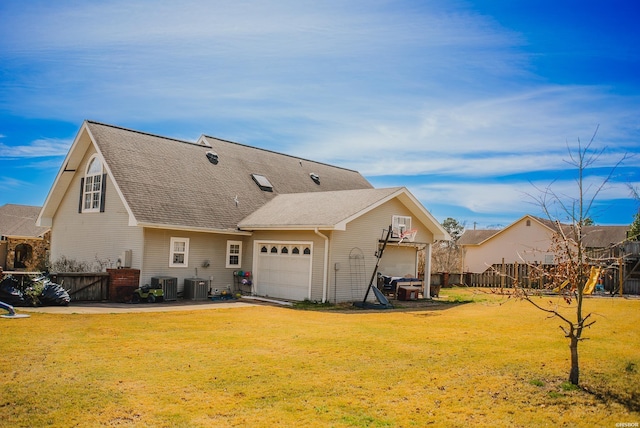 view of front of house featuring central AC, roof with shingles, a front yard, and fence