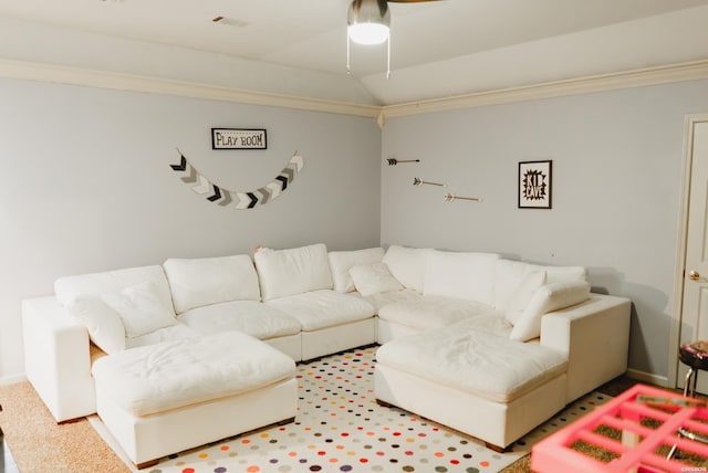 living area with lofted ceiling, ornamental molding, carpet, and baseboards