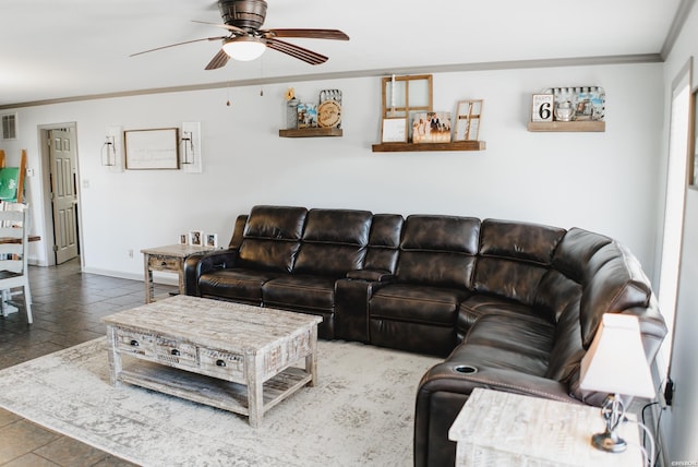 living room with ceiling fan, visible vents, baseboards, and crown molding