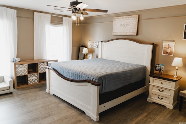 bedroom with ceiling fan and wood finished floors