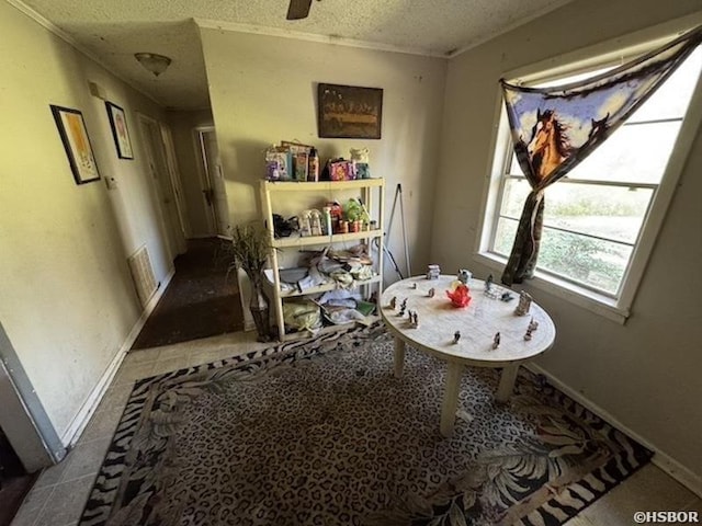 dining area featuring baseboards, a textured ceiling, and tile patterned floors