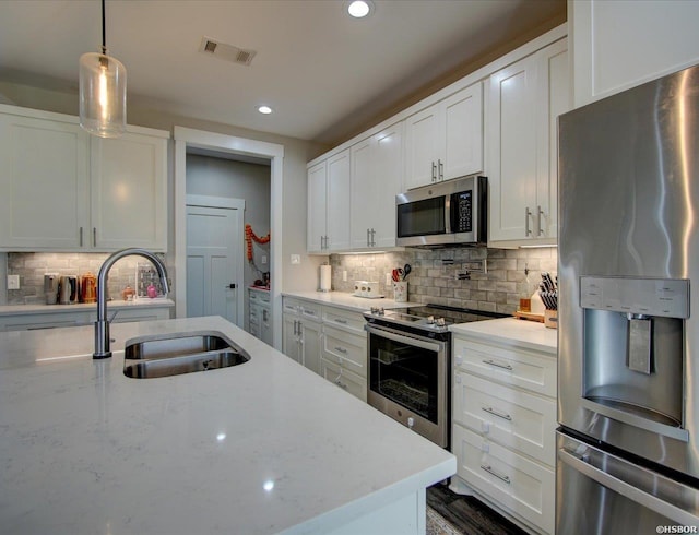 126 Luek Ln, Hot Springs, AR 71913 - kitchen with light stone counters, stainless steel appliances, a sink, visible vents, and white cabinets