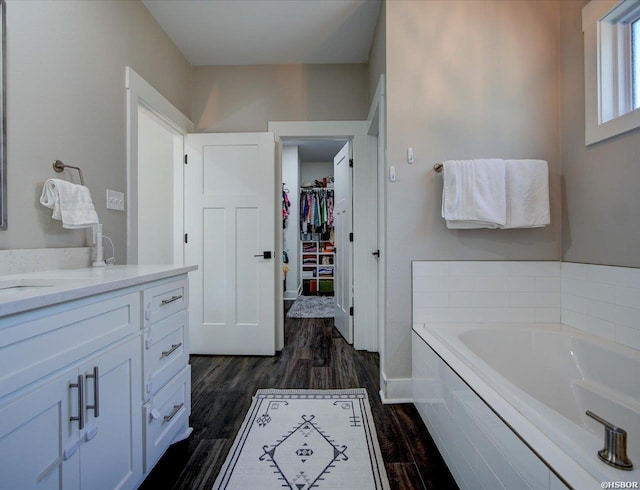 126 Luek Ln, Hot Springs, AR 71913 - full bathroom featuring vanity, wood finished floors, a walk in closet, and a bath