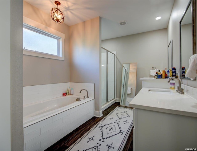 126 Luek Ln, Hot Springs, AR 71913 - bathroom with wood finished floors, vanity, visible vents, a bath, and a stall shower