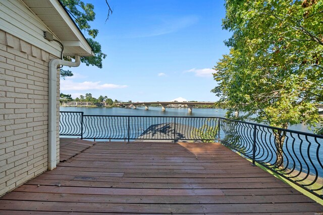 wooden terrace featuring a water view