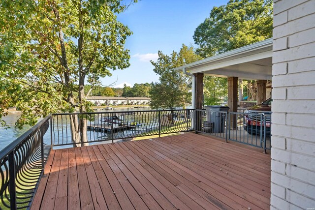 wooden terrace featuring a water view