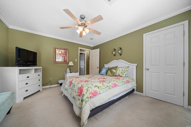 bedroom featuring ceiling fan, baseboards, crown molding, and light colored carpet