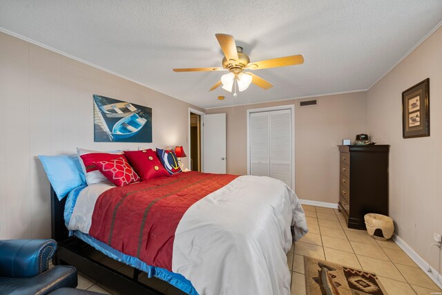 bedroom featuring visible vents, crown molding, a textured ceiling, a closet, and light tile patterned flooring