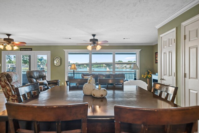 dining space with visible vents, crown molding, a textured ceiling, and ceiling fan