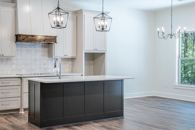 kitchen with a chandelier, custom exhaust hood, and decorative backsplash
