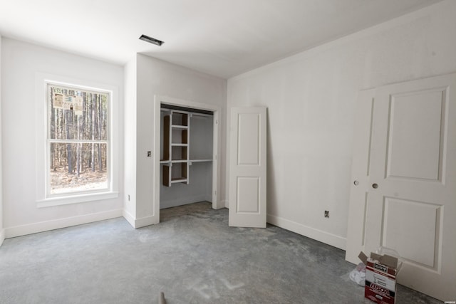 unfurnished bedroom featuring visible vents, baseboards, and carpet flooring