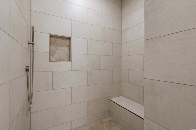 full bathroom with a tile shower