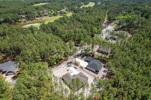 aerial view featuring a forest view and a water view