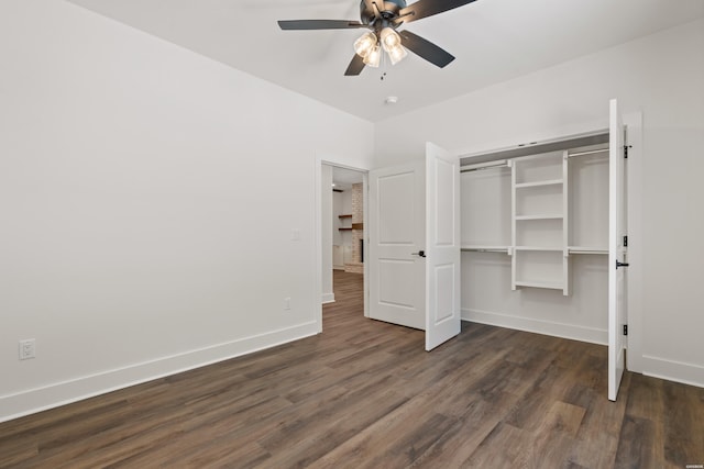 unfurnished bedroom featuring baseboards, a closet, and dark wood finished floors