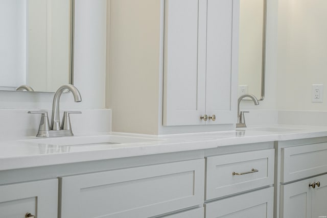 bathroom with a sink and double vanity