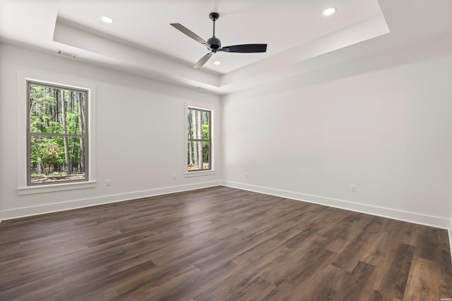 unfurnished room featuring baseboards, visible vents, and a raised ceiling