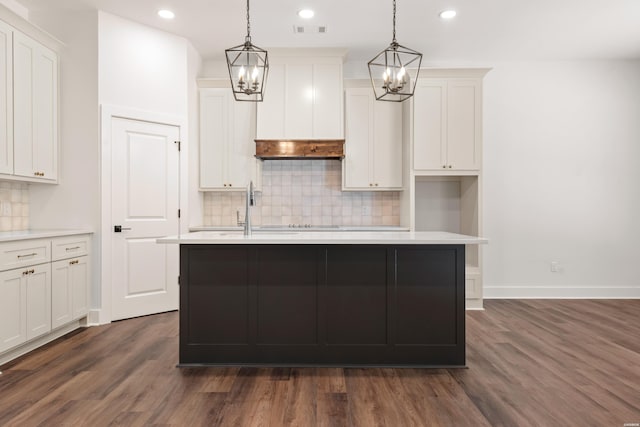 kitchen featuring light countertops, white cabinetry, visible vents, a notable chandelier, and dark wood-style floors